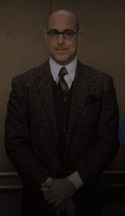 Nigel, ever the sartorial guide, presents a polished professional ensemble featuring a richly textured blazer and a sharp pinstripe vest, embodying a sophisticated office aesthetic.